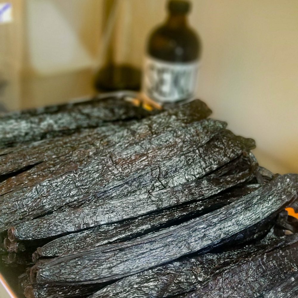 Photo of a neatly-stacked pile of pompona pods in a shop window